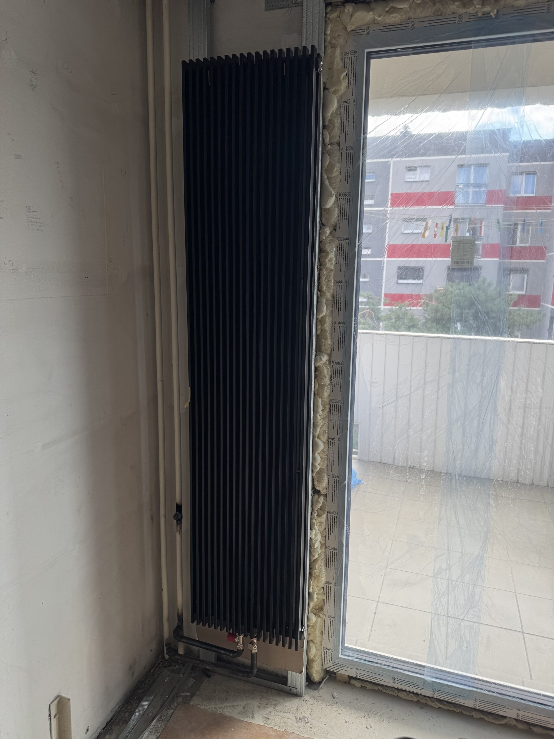 Dekoracyjny grzejnik pionowy w salonie w Krakowie